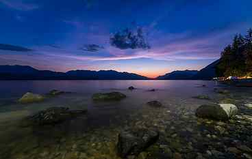 timelapse photography of body of water near mountain during golden hour HD wallpaper