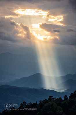 Sunlight shining through hole of clouds to dark mountain, sun rays shining through tree HD phone wallpaper