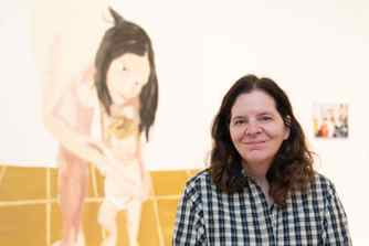Chantal Joffe stands in front of her self-portrait Mother and Child II (2005) at the Real Families: Stories of Change exhibition.