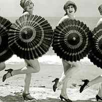 Bathing beauties with parasols by American School