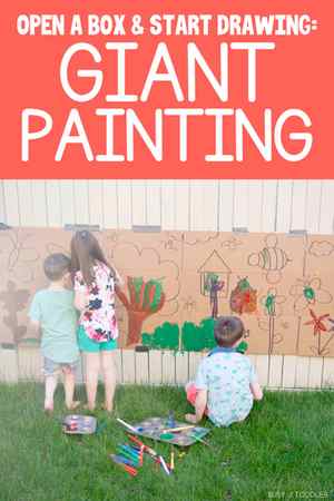 Kids painting on a cardboard box with a giant art project.