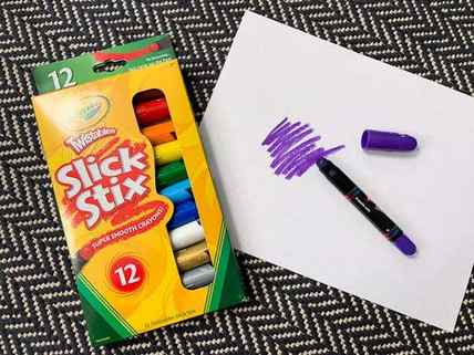 a pack of Crayola Slick Stixs, with a drawing next to them.