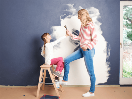 Two girls applying Wall Painting Ideas