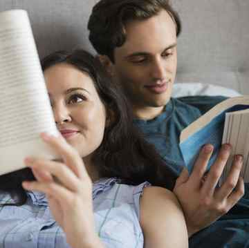 couple reading next to each other in bed