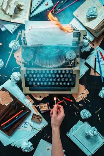Overhead shot of a typewriter and messy writer