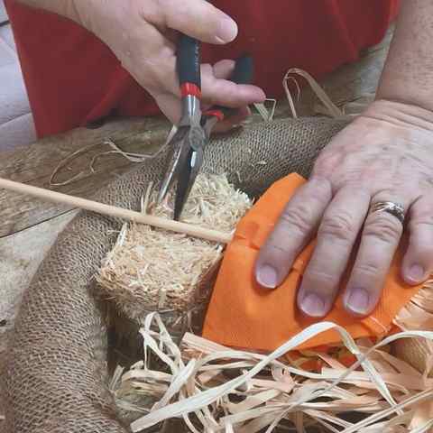 adding a scarecrow to a fall wreath