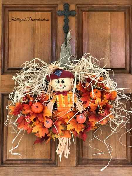 How To Make A Scarecrow Wreath using Dollar store supplies. Fall Wreath tutorial using faux fall leaves and a Scarecrow for the center. #fallwreath #diyfallwreath #scarecrowwreath #diydecor #craft #fallcraft #fall