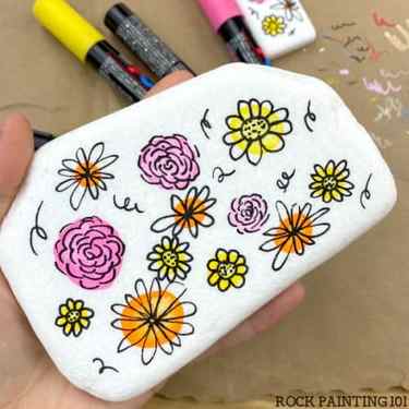 Simple flowers painted onto a rock.