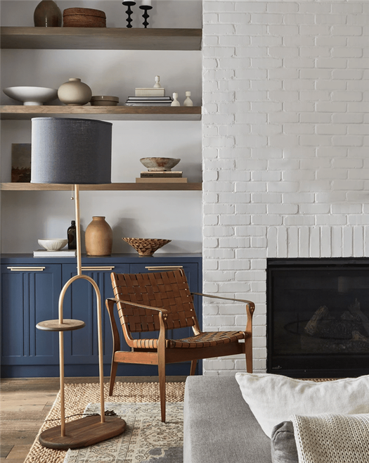 A living room with a pop of indigo cabinetry