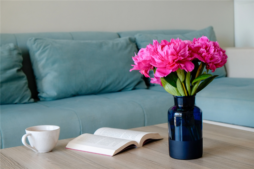 Peonies in a vase on a coffee table