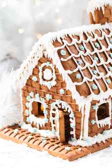 Homemade gingerbread house white christmas tree and garland light