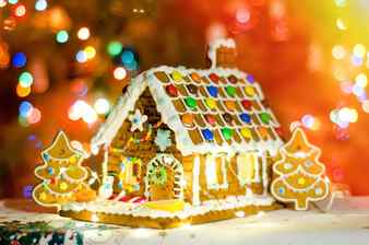 Gingerbread house with blurred garland lights background