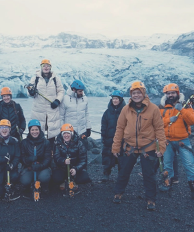 group posing for picture on iceberg