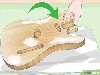 Step 1 Lay the guitar down on a flat surface.