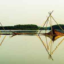 Triangles Of Bamboo Stick On Lake by Pham Le Huong Son