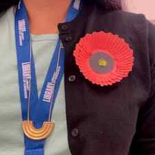 A finished paper poppy pin.