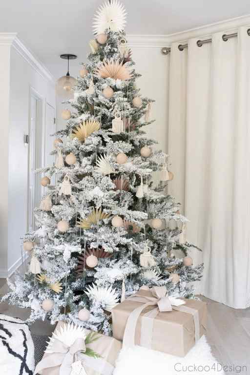 pastel flocked Christmas tree with lights off so you can see baking soda painted Christmas ornaments