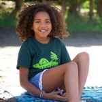Load image into Gallery viewer, Female wearing dark green Unisex Youth Camp Scene T-shirt. Bright green Camp Scene logo screened on centre chest. 