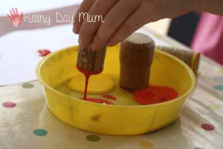 using a cork for printing. a child