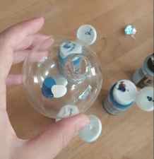 blue, silver, and white paint drops in a glass ornament