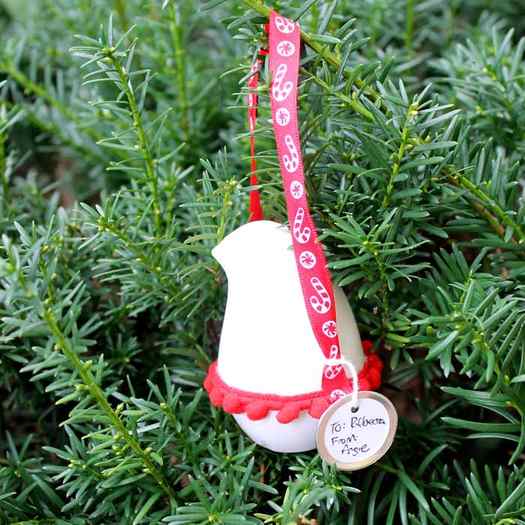 close up image of bird christmas ornament hanging on a Christmas tree