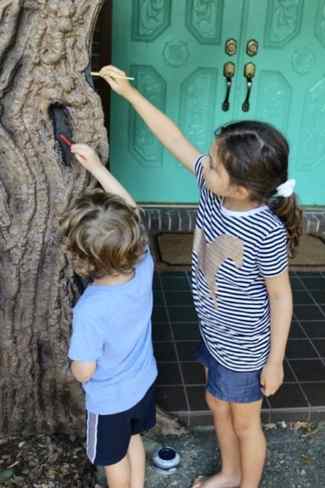 helping paint halloween tree